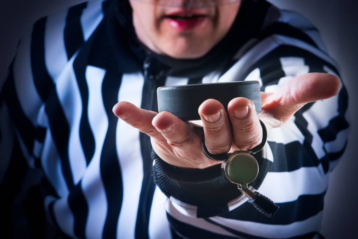 What communication equipment do ice hockey referees need?